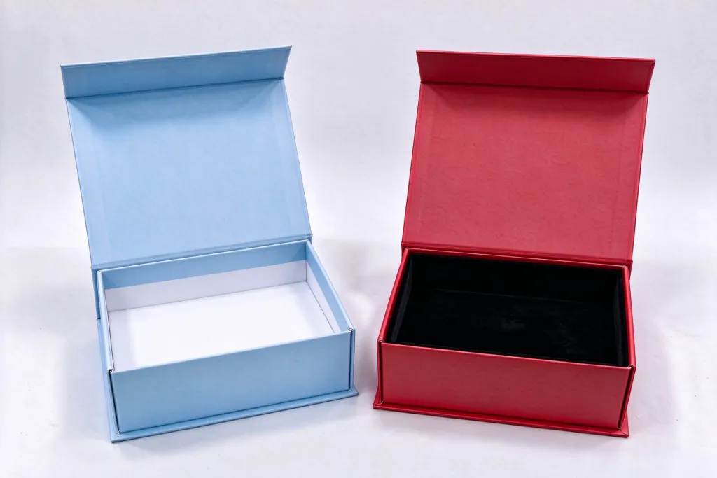 two similar gift boxes compared side by side, one with insert and protective packing